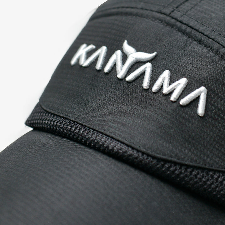 Close-up of black Kanama fishing sun hat showcasing embroidered logo.